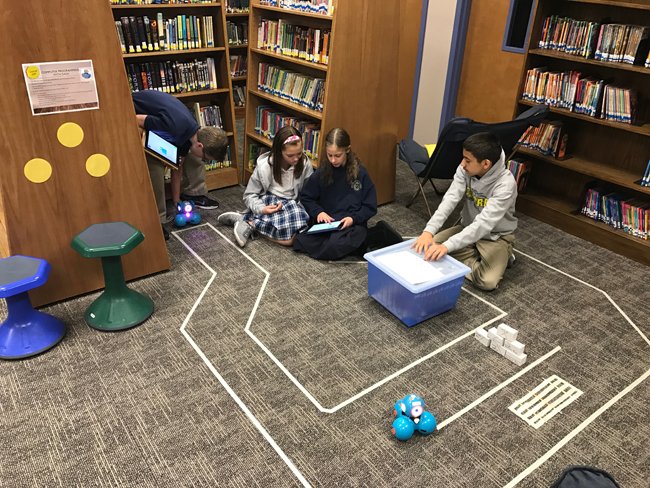 -- Students Programming DASH robots in a course --